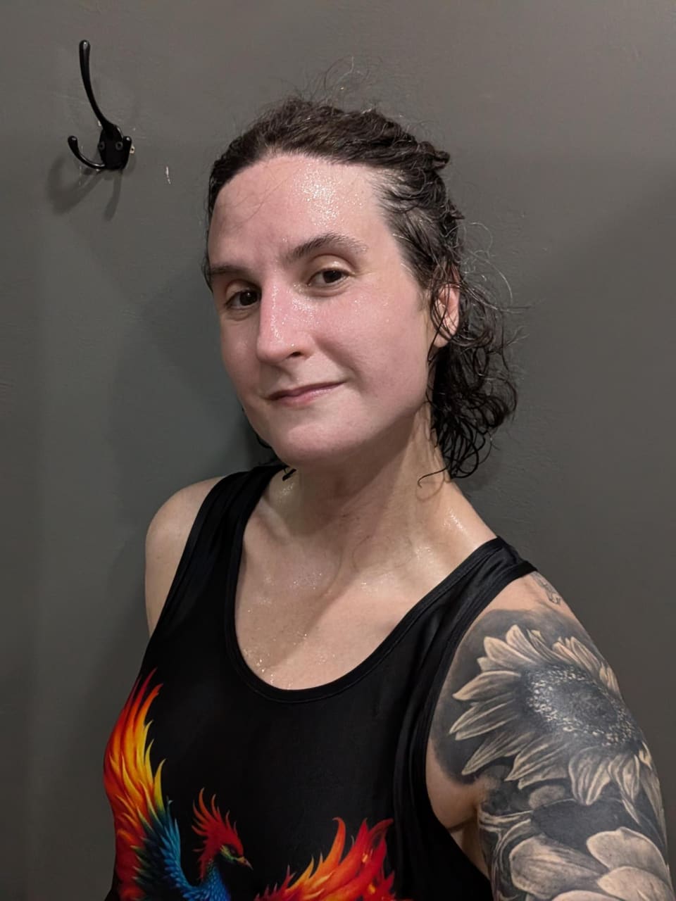 Quinn after a session, in a phoenix tank top, looking at the camera.